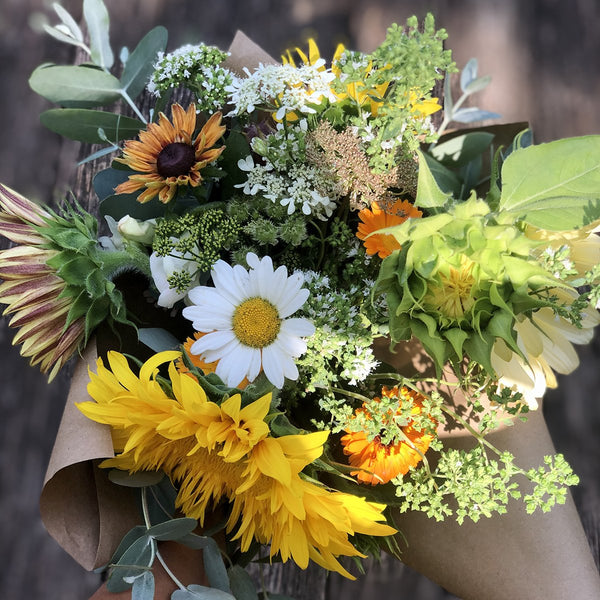Greensboro, NC | Our locally-grown, pesticide-free summer flowers are finally here! Everything is either blooming or ready to pop this month – sunflowers in shades of plum, cream yellow, dark red, and radiant gold, lisianthus that are soft like roses, the always-a-hit zinnias, the ever cheerful daisies, and a range of herb and edible flowers like calendulas, oregano, and basil. We can't be more excited to share with you that broad range of summer flowers, and labor of our garden love!